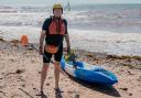 Alistair McKenna on Sidmouth town beach with his kayak