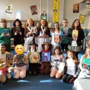 Sidmouth Primary School pupils and staff with their new library books