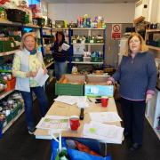 volunteers Jane, Ness and Kill in the Food Bank