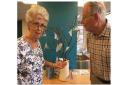 Ann Challis and Jeffrey Try admire the moths they made for the COP26 art installation.
