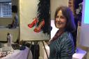 Artist Christine Russell with her red high heels and black feather boa
