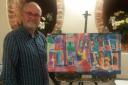 Artist Tony Homer and two of his paintings on his easel. Credit Terrence Cook.