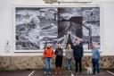 Photographer Paul Newman, Cllr Louise Cole, community artist Coco Hodgkinson, artist David Shrigley and Cllr Ian Barlow with the latest billboard display