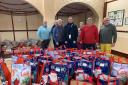 Sidmouth Rotary Club members with Simon Jupp MP and the gift bags ready for distribution last Christmas