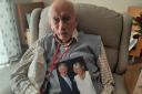 Ron Day with his 100th birthday card from King Charles and the Queen Consort