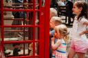 Children are attracted to the new phone box exhibition space, currently displaying Pelham Puppets