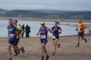 Winning Woman Claire Stone in the 1st mile on the beach