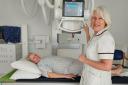 Radiographer Alison Oughton x-raying Sandra Chandler, who became the first patient to use the machine.