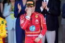 Charles Leclerc celebrates on the podium (AP Photo/Luca Bruno)