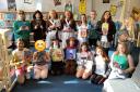 Sidmouth Primary School pupils and staff with their new library books