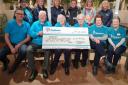 Hospiscare volunteers and Otter team members with the Hospiscare conation cheque
