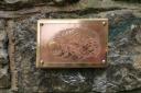 One of the nine brass rubbing plates at Sidmouth's Riverside Walkway
