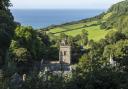 Salcombe Regis Parish Church in its beautiful setting, overlooking fields and the view towards the sea