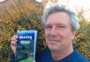 First-time author Geoff Purkiss with his book