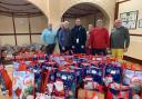 Sidmouth Rotary Club members with Simon Jupp MP and the gift bags ready for distribution last Christmas