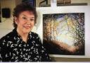 Sidmouth artist Lynda Kettle with one of her paintings
