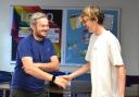 Student T Prismall is congratulated by Mr Adkins
