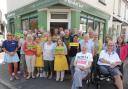 Staff, volunteers and customers of the Mustard Seed Cafe. Debbie Brown is front centre holding a 'Thank You' sign.