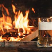 Not much beats a pint in front of a pub's open fire in winter