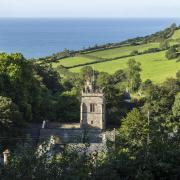 Salcombe Regis Parish Church in its beautiful setting, overlooking fields and the view towards the sea