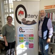 Librarian Kerry Carr and John Hall, chair of Ottery Writers, in the town's library
