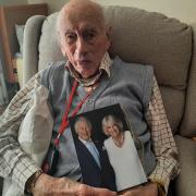 Ron Day with his 100th birthday card from King Charles and the Queen Consort
