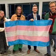East Devon councillors Jake Bonetta and Joe Whibley with the Transgender flag