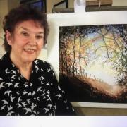 Sidmouth artist Lynda Kettle with one of her paintings