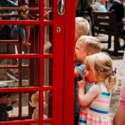 Children are attracted to the new phone box exhibition space, currently displaying Pelham Puppets