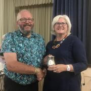 Roger Cozens receiving the Challenge Tankard Cup from Lady Cave