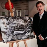 Producer Paul Tully with film poster at the documentary's premiere at the Radway last summer