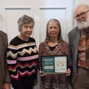 Cllr Rosemary Walker accepting the award with Climate Change Group volunteers Gill Cameron Webb, Ted Swan and Chris Lea.