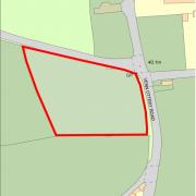 Land in Newton Poppleford earmarked for five new houses.