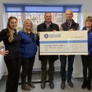 The team at Otter Vets presenting a cheque of £1,000 to Sidmouth Hospice at Home