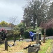 Volunteers clearing grass cuttings at Sidmouth Cemetery