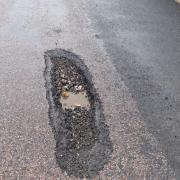 A pothole next to the patched-up section where Mr Lee's car was damaged